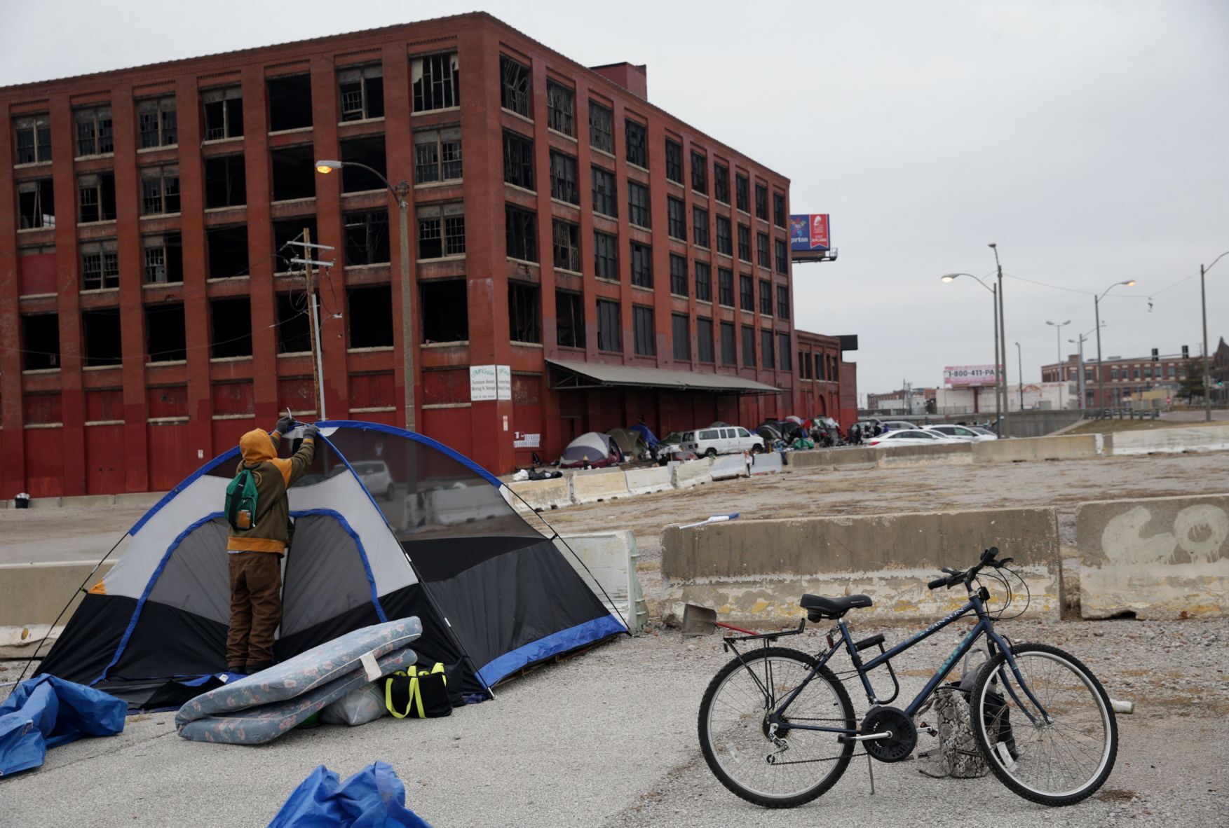 Tent encampment outside vacant McGuire Moving & Storage building